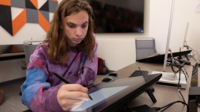 A student draws on a Cintiq.