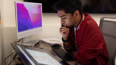 A student ponders their next move as they draw on a Cintiq.