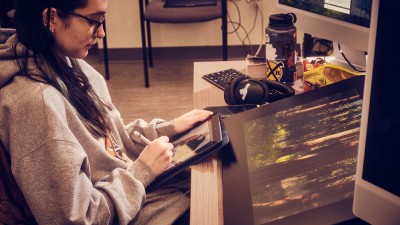 A student digitally draws.