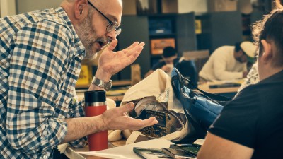 RIT faculty Mitch Goldstein talks with a student during the 2D Design class.