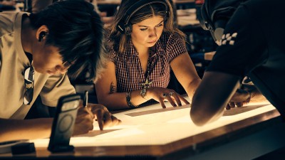 RIT foundations students draw designs on paper.