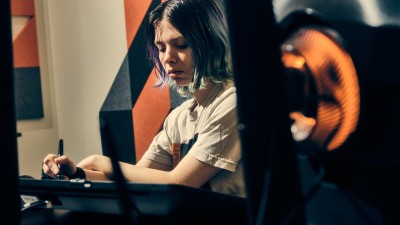 a student focuses on her drawing.