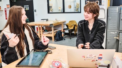 Two smiling students in the industrial design studio.
