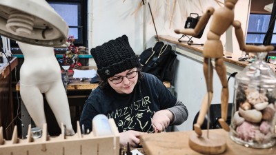 A student works at their workspace in the metals studio.