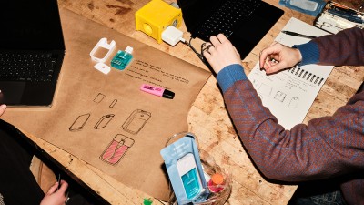 An overhead view of student sketches and materials.