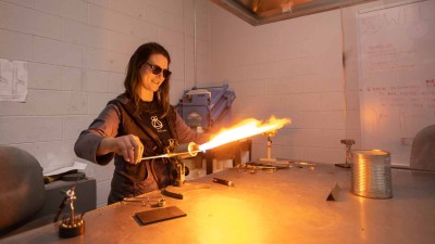 Student igniting a torch to heat metal