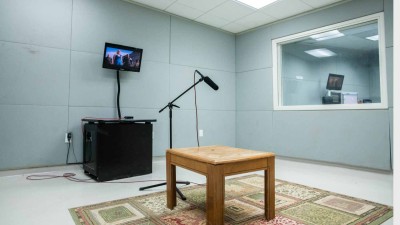 Sound recording room with an empty table on a carpet 