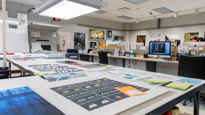 Photo prints sit on a table in I S L.