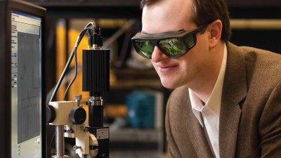 Man looking at instrument wearing special glasses.