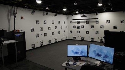 a room with Q R codes on the walls, and desks with computer equipment.