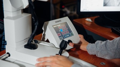 a student operates a keypad as part of the eye machine.