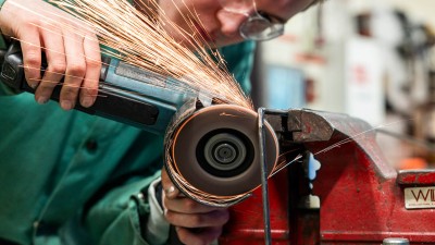 closup of a grinding wheel making sparks as it contacts the metal.