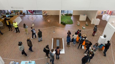 An overhead view of people taking in an exhibition in Bevier Gallery. 