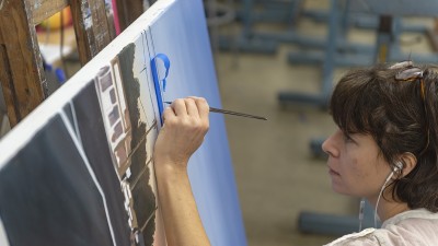 A detailed shot of a student painting.