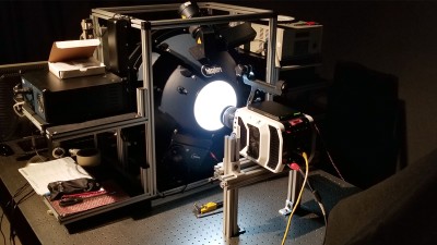 calibration instrument with a camera pointed toward a glowing orb.