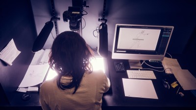 overhead view of a student working on the lighted glass surface.