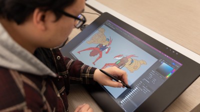 a student changes layers in Photoshop on his Cintiq.