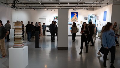 A wide view of a gallery opening of a fine art photography capstone show. 