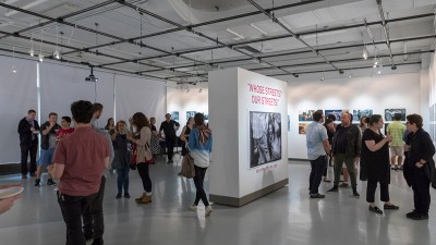 A group of people during an opening inside William Harris Gallery. 