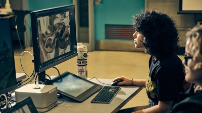 An RIT illustration student works at a computer station.