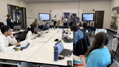 A wide view of a conference in one of RIT's interior design spaces.