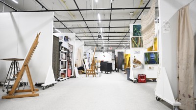 A wide view of a new painting studio with individual work spaces.