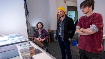 professor and students look at images on a light table.