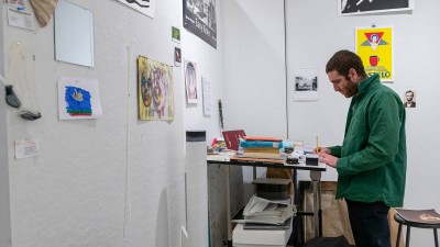 a student draws at a work space.