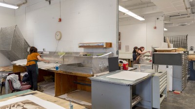 A wide shot of the printmaking studio with several work stations.