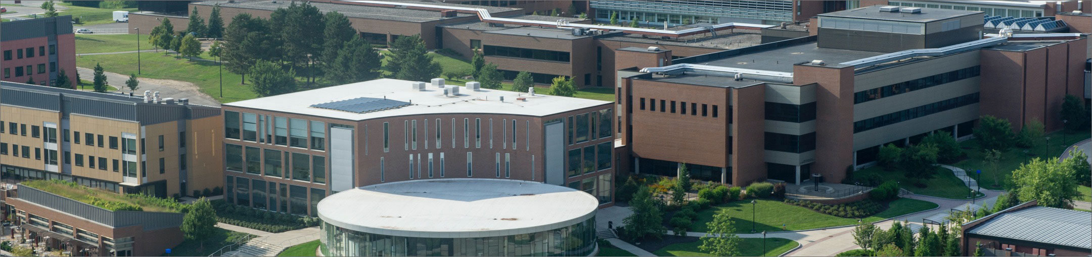 An aerial view of the R I T campus, centered around the Innovation Center.