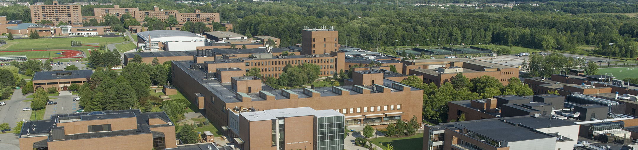 Aerial photo looking at Vignelli Center for Design Studies, James E. Booth Hall, George Eastman Hall, Gordon Field House, and a number of residence halls on RIT's Campus 