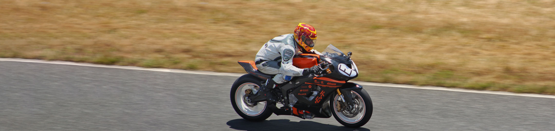 A motorcycle rider driving around a racetrack
