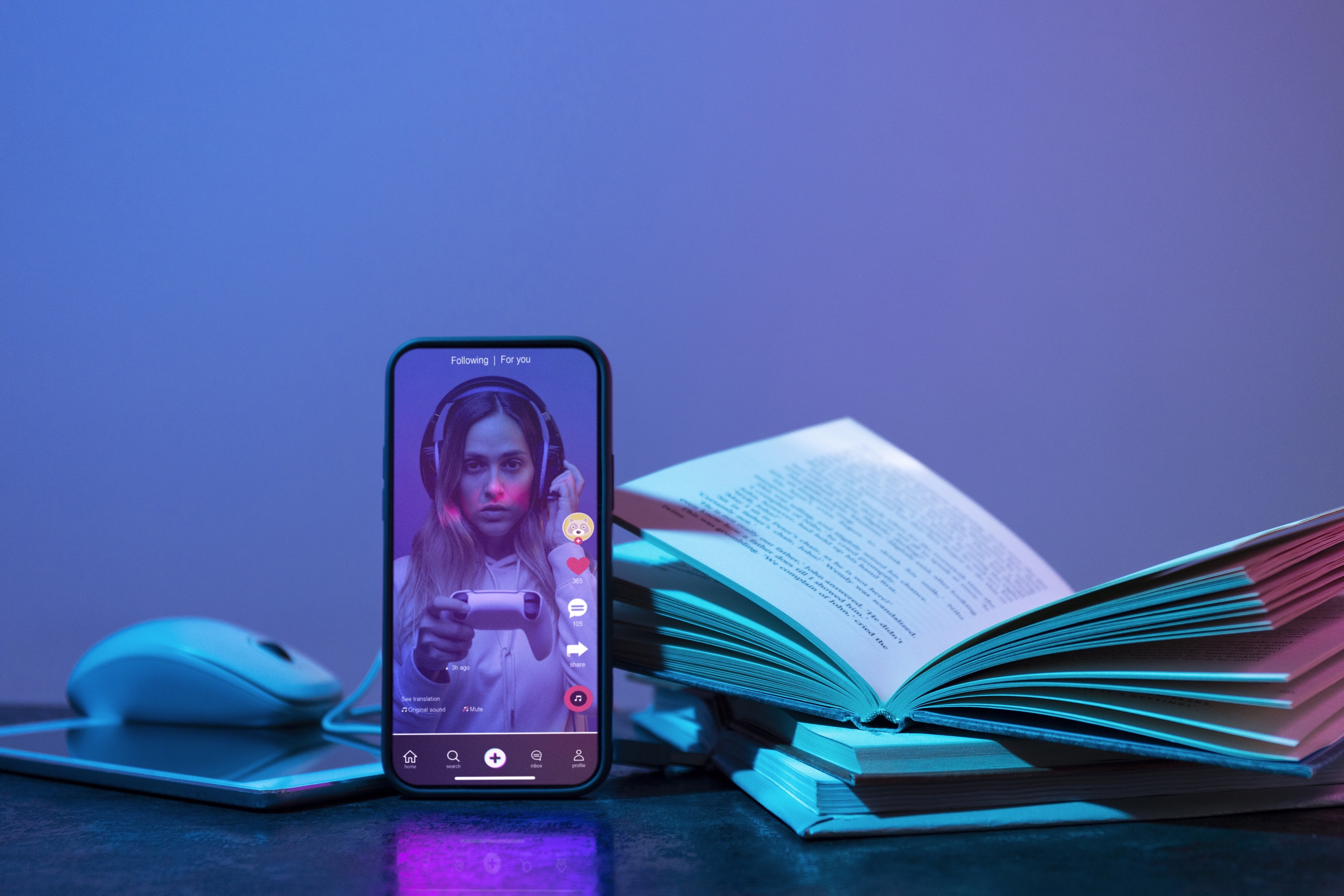 books alongside mobile phone featuring woman's face