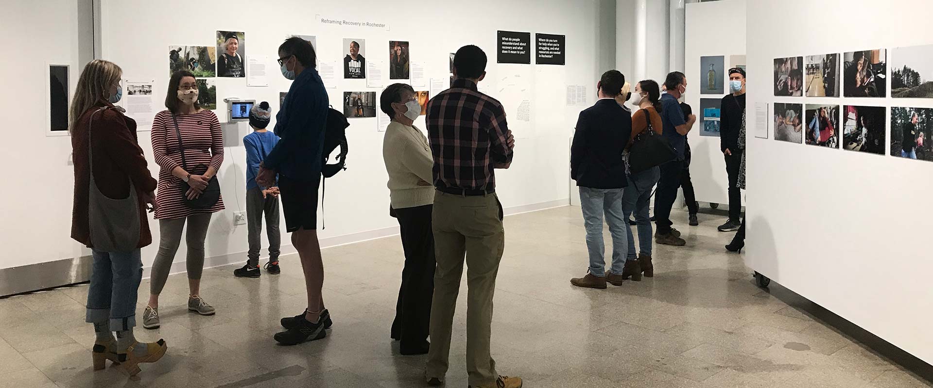 a group of people gathered in an art gallery.