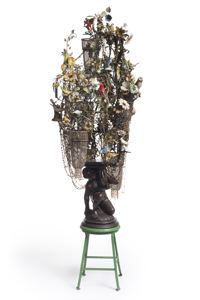 sculpture of found objects blooming from stool