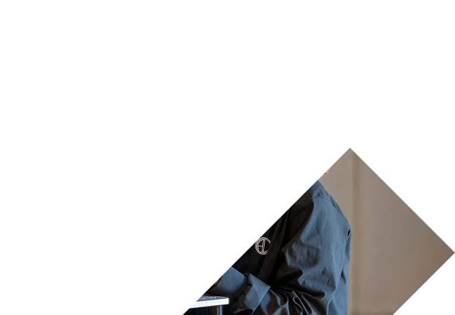 woman smiling while holding a film camera