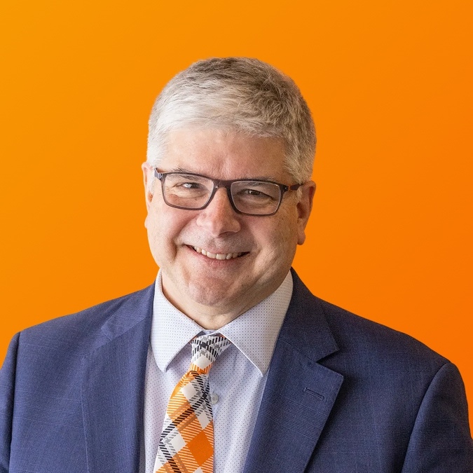 Portrait of Bill Sanders on an orange background
