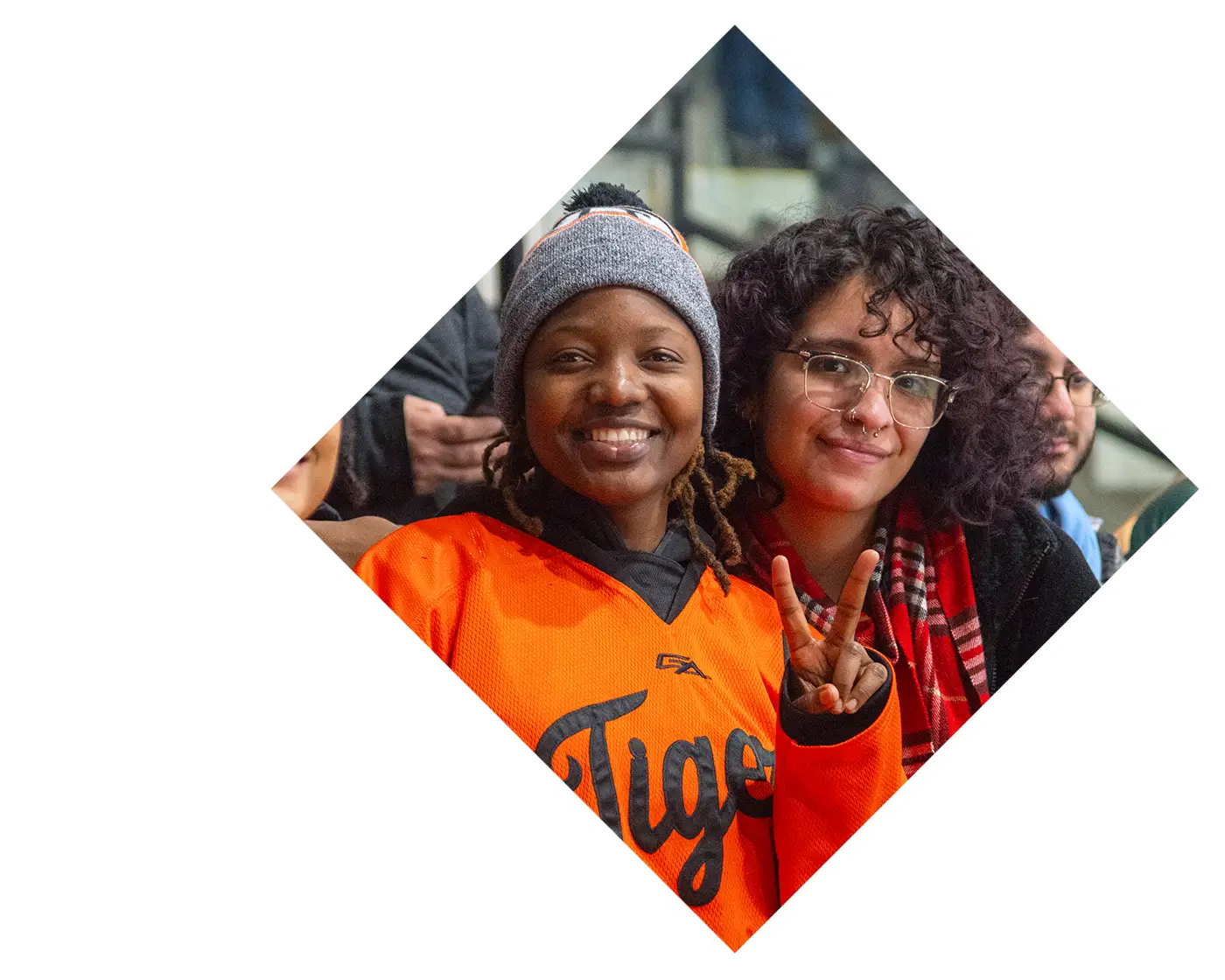 RIT flared people showing a peace sign to the camera while smiling