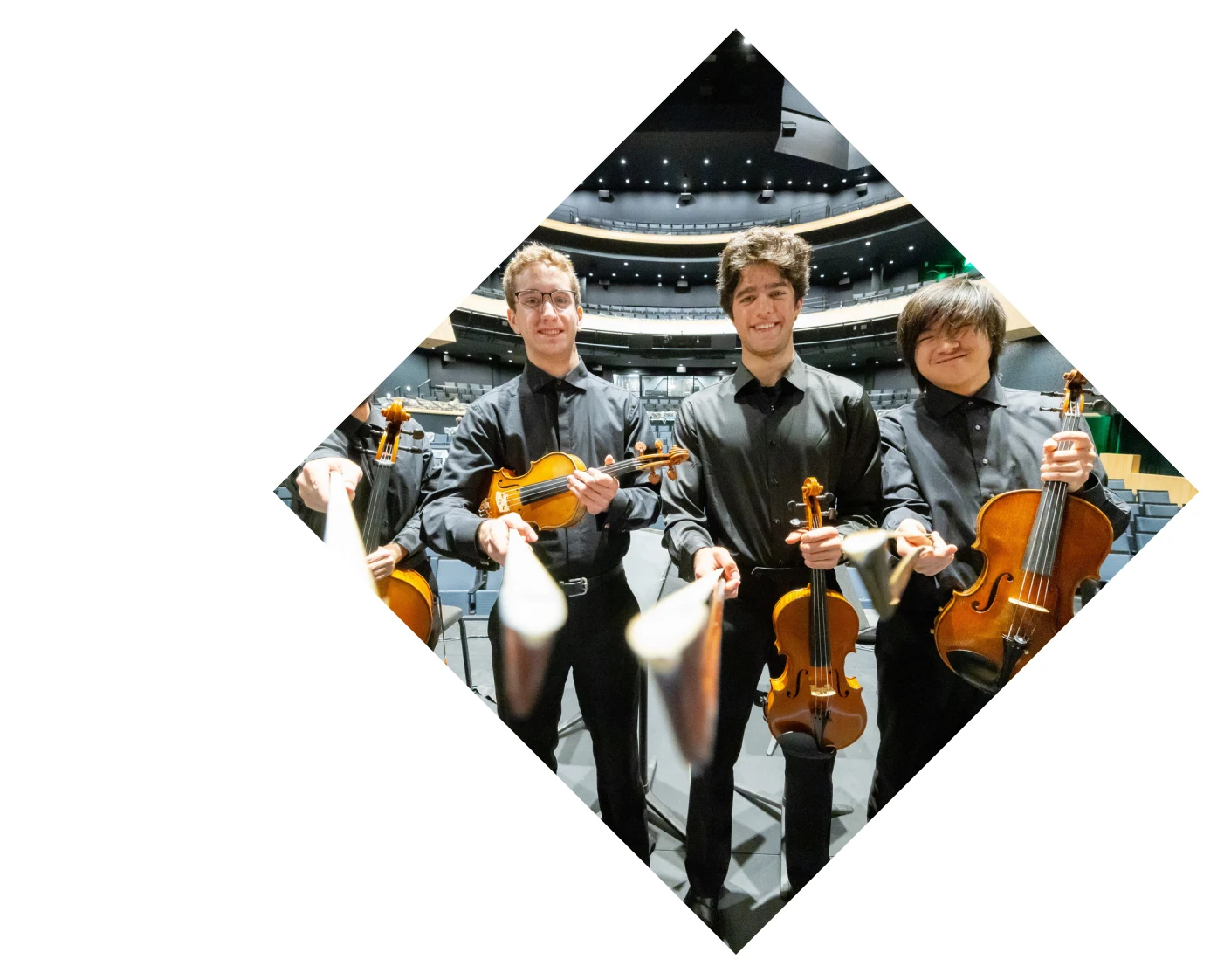 RIT student using a hose to water what appears to be a garden