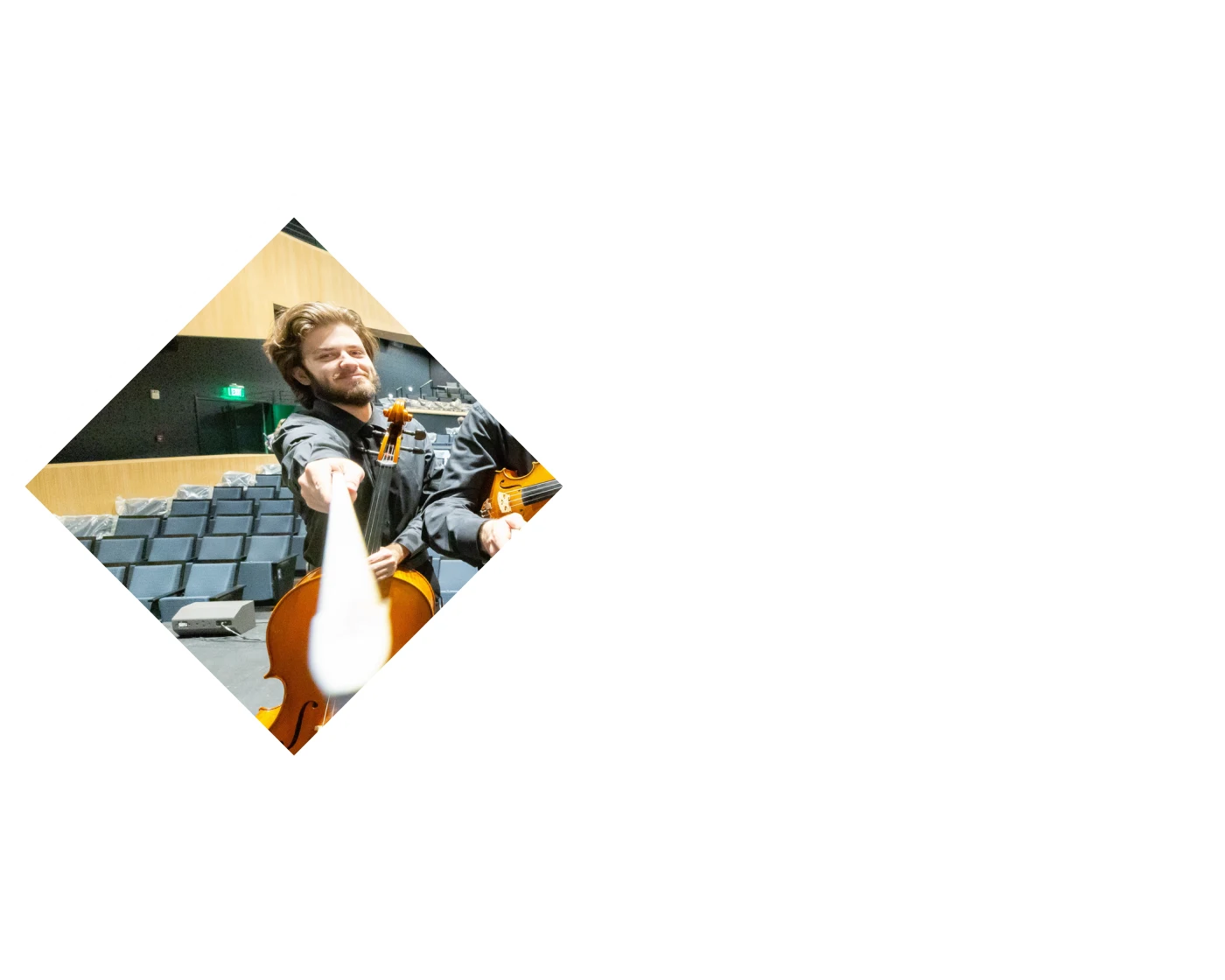 RIT student using a hose to water what appears to be a garden