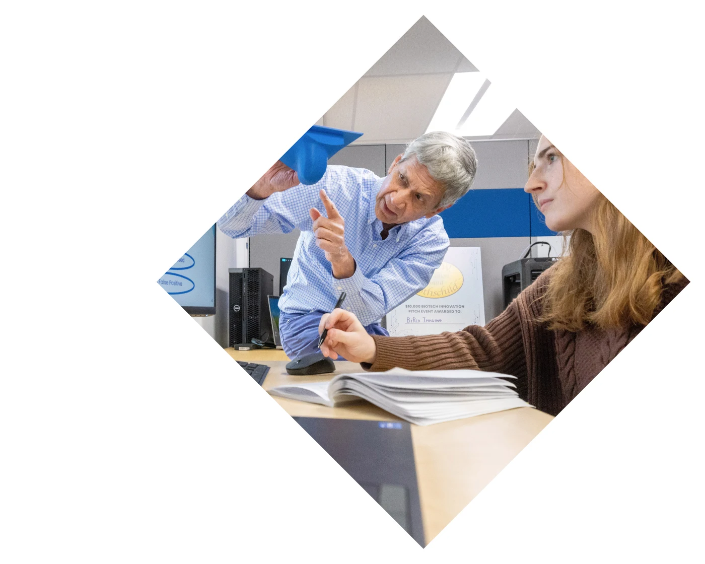 Professor showing something to a student