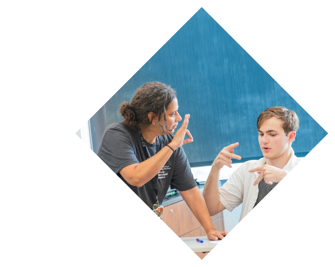 Two people signing ASL to each other