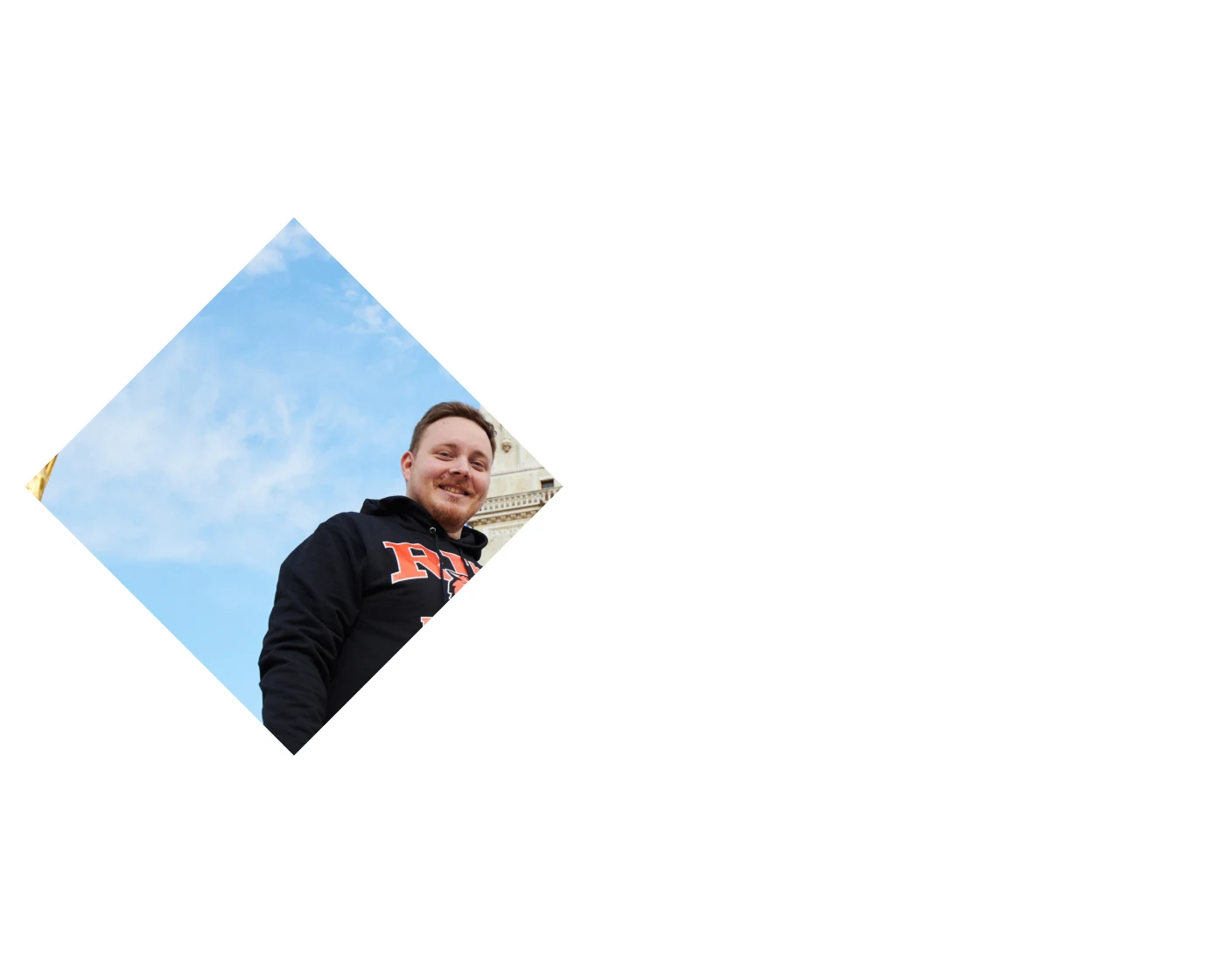 Students in RIT gear standing in front of an old building