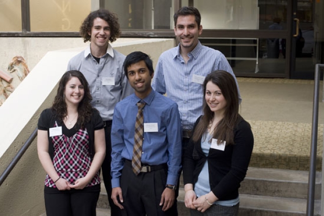 People posing for award at event