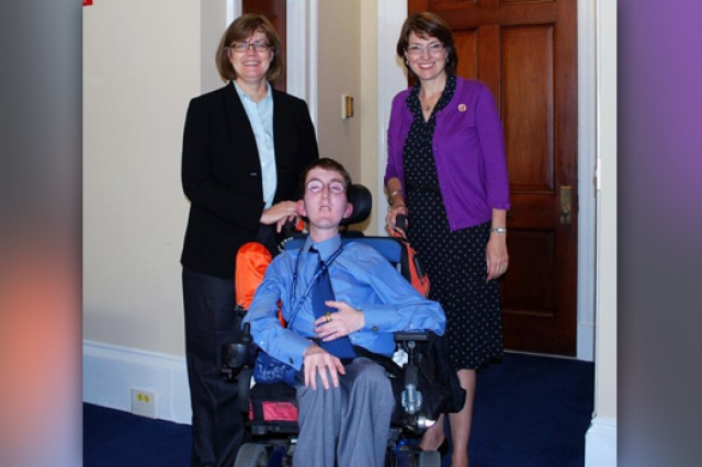 Three people posing for camera