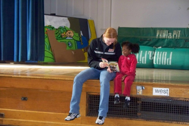 Person showing book to child