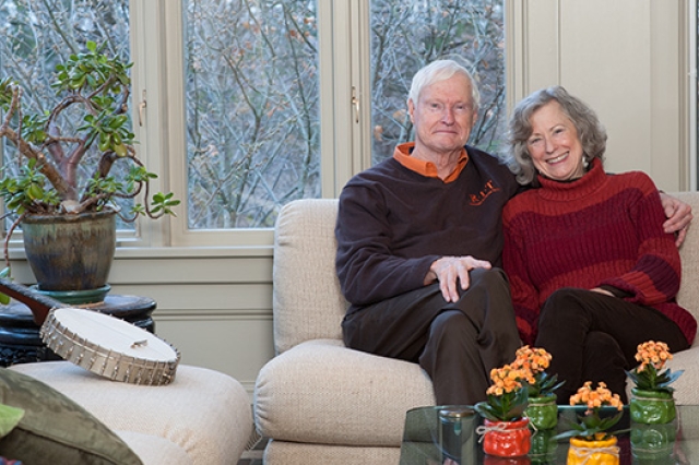 RIT President Bill Destler posing on couch with his wife