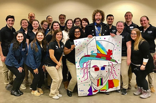 Members of the College Activities Board pose for a photo with T.J. Miller.