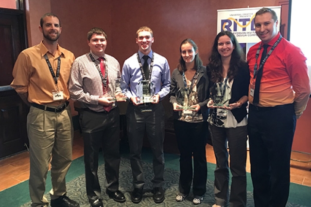 People gathered with trophies for picture