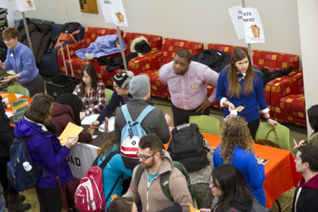 People gathered at event speaking to vendors